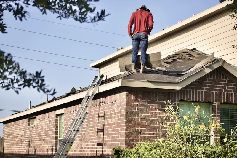 Professional roofer working on a residential roof in Hooksett